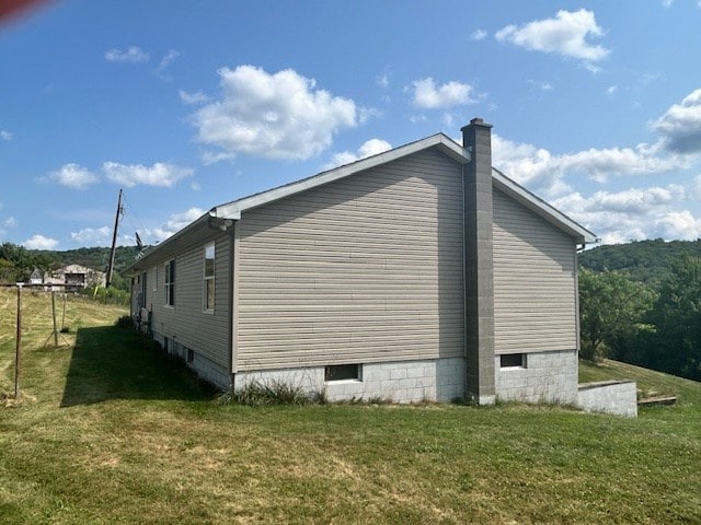 view of property exterior with a yard