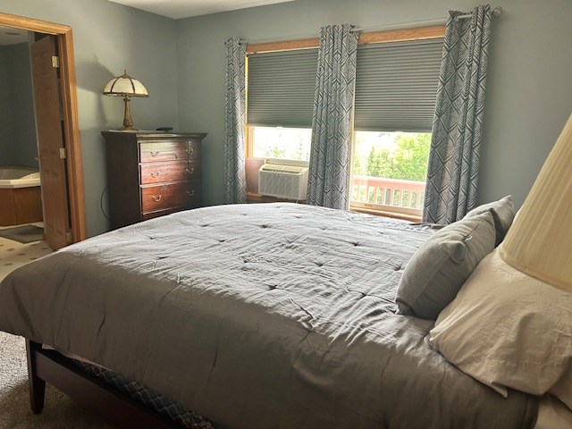 carpeted bedroom with cooling unit