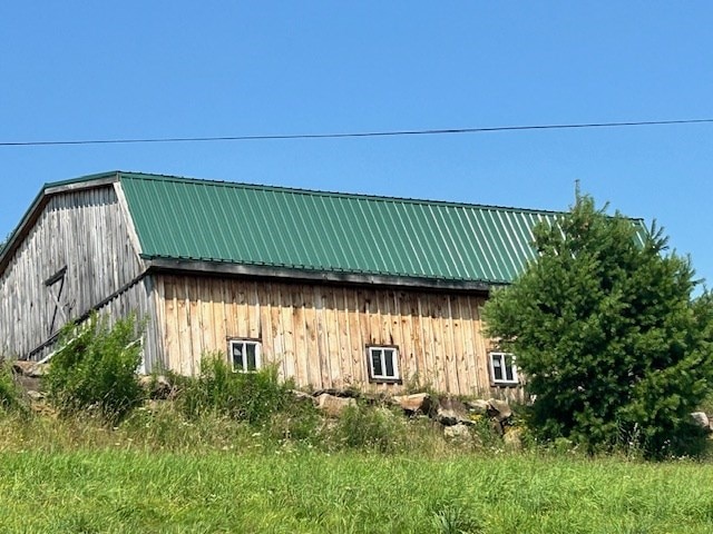 view of home's exterior with an outbuilding