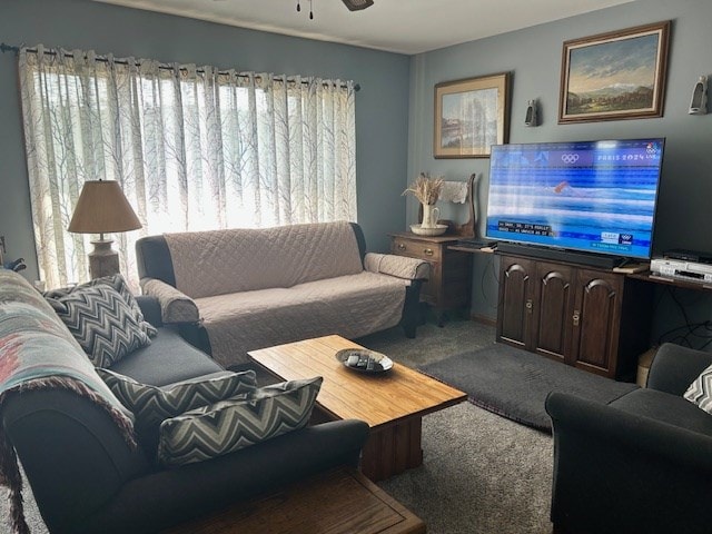 carpeted living room featuring ceiling fan and plenty of natural light