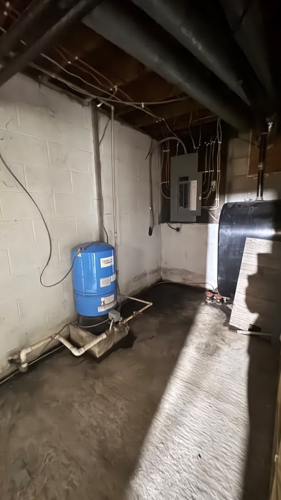 8380 Sheshequin Rd, Athens, PA 18810 - unfinished below grade area with heating fuel, a water pressure tank, and electric panel
