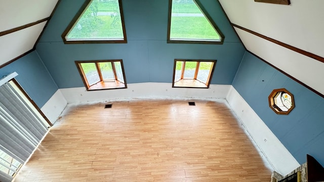 8380 Sheshequin Rd, Athens, PA 18810 - unfurnished living room with wood finished floors and high vaulted ceiling