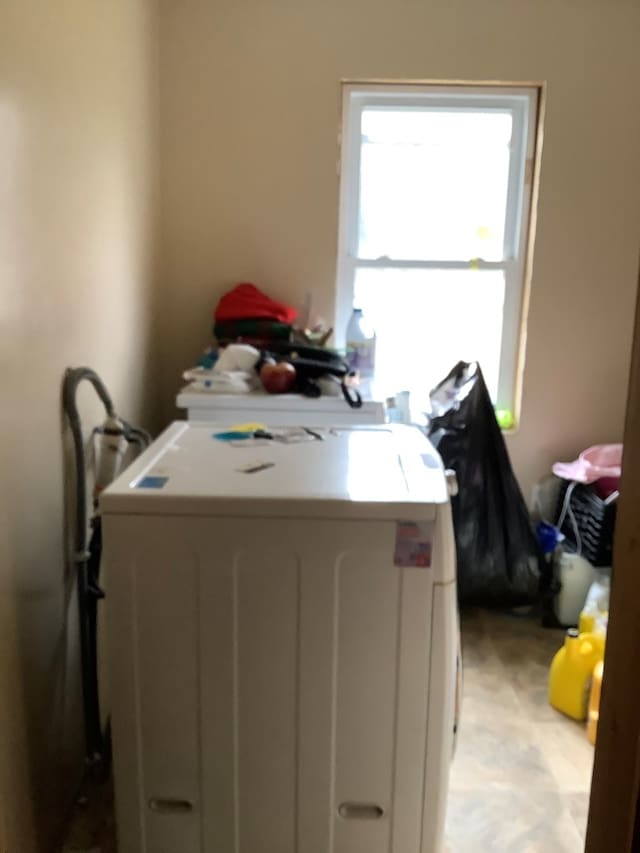 clothes washing area featuring washer and clothes dryer