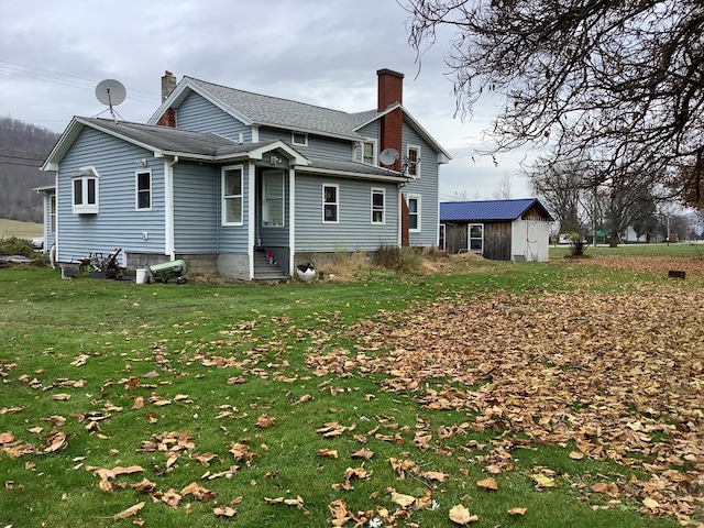 back of house with a lawn