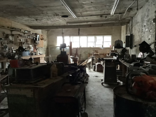 miscellaneous room featuring a workshop area and concrete flooring