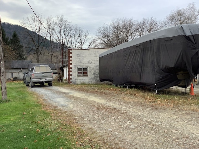 view of property exterior with a mountain view