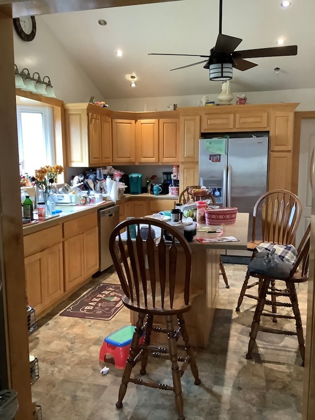 kitchen featuring ceiling fan, light brown cabinets, lofted ceiling, and appliances with stainless steel finishes