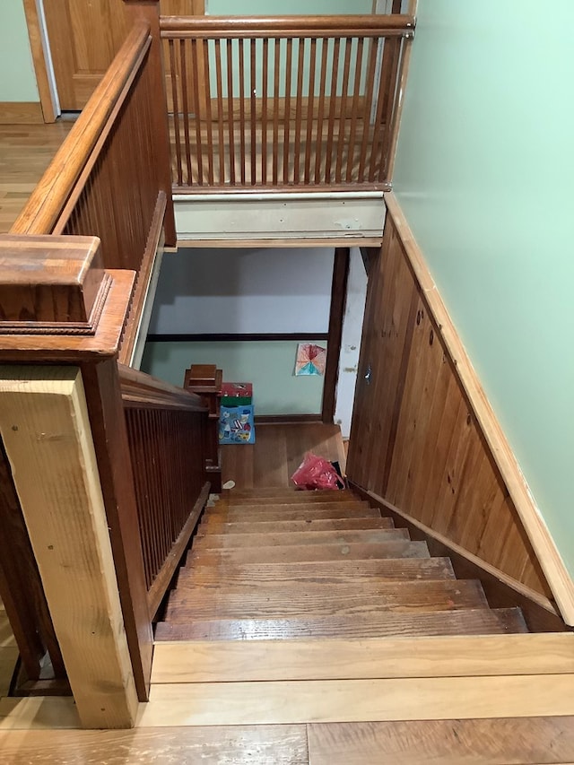 stairs featuring wooden walls