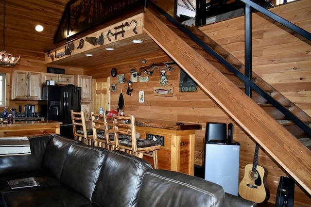 living room with high vaulted ceiling, wooden ceiling, and wood walls