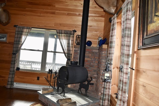 exercise room featuring baseboard heating and wood walls