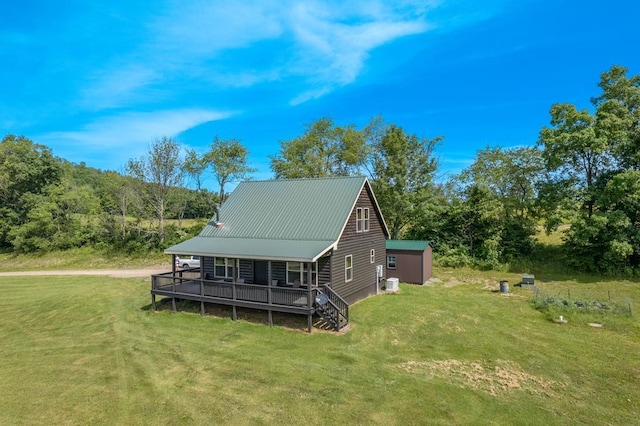 back of property featuring a lawn and a shed