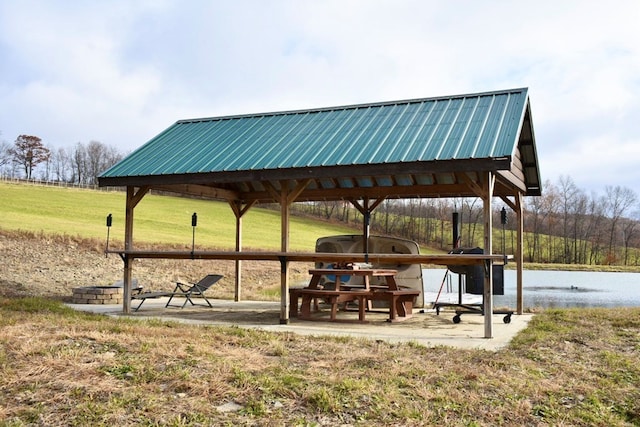 view of home's community featuring a gazebo, a lawn, and a water view