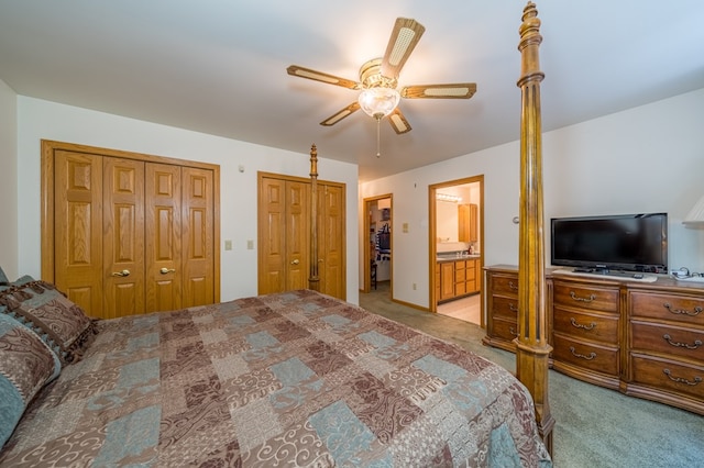 105 Laurel Ln, Sayre, PA 18840 - bedroom with light colored carpet, two closets, a ceiling fan, and ensuite bath