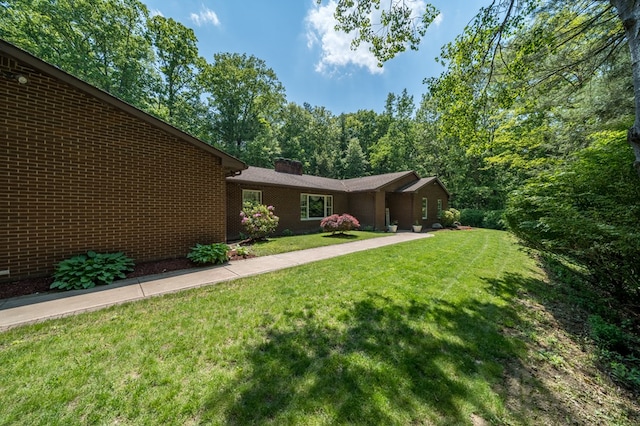 105 Laurel Ln, Sayre, PA 18840 - view of front of property featuring a front lawn, brick siding, and a chimney