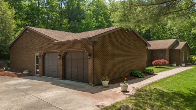 105 Laurel Ln, Sayre, PA 18840 - view of property exterior featuring brick siding, a garage, and a shingled roof