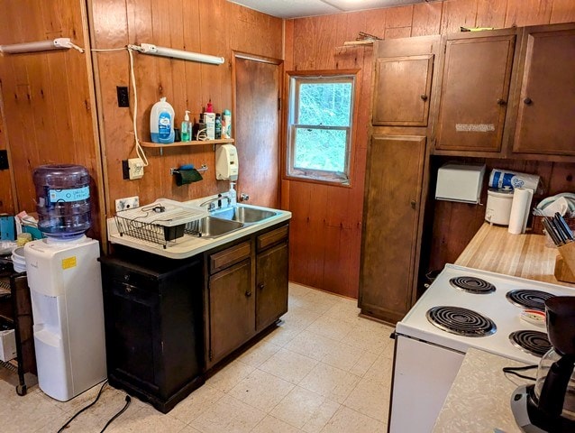 198 Spring Run Rd, Smethport, PA 16749 - kitchen with electric range, light countertops, wooden walls, light floors, and brown cabinetry