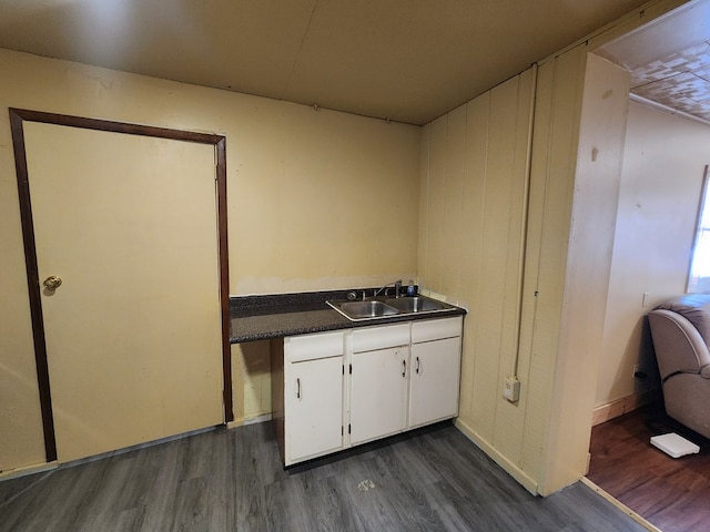 kitchen featuring white cabinetry, sink, and dark wood-type flooring