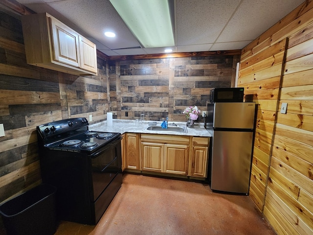 kitchen featuring a drop ceiling, sink, wooden walls, and black appliances