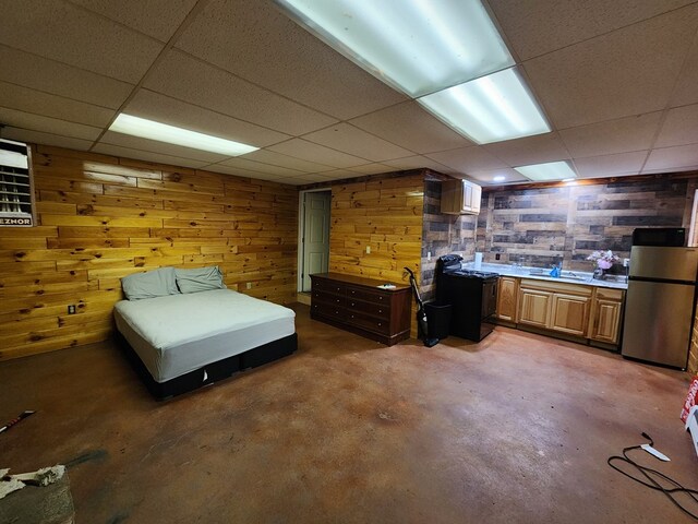 504 S E St, Coudersport, PA 16915 - bedroom featuring a drop ceiling, freestanding refrigerator, concrete flooring, wood walls, and a sink