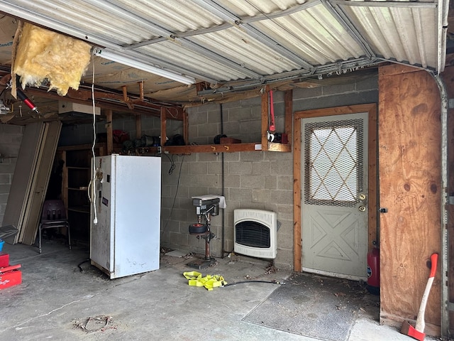 3092 Rte 155, Port Allegany, PA 16743 - garage featuring heating unit, freestanding refrigerator, and concrete block wall