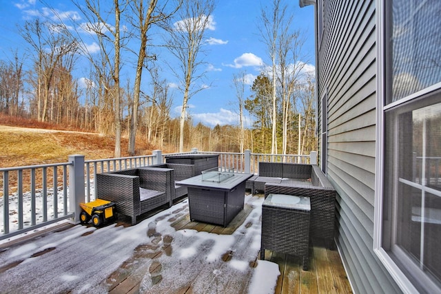 wooden deck featuring an outdoor living space with a fire pit