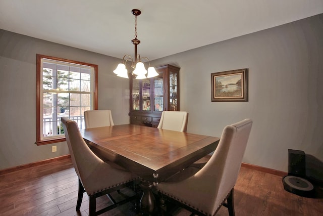 dining room featuring a chandelier and dark hardwood / wood-style flooring