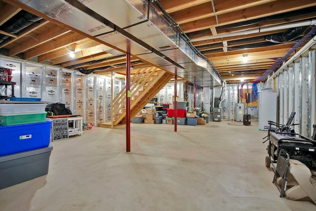 basement featuring electric water heater, water heater, and heating unit