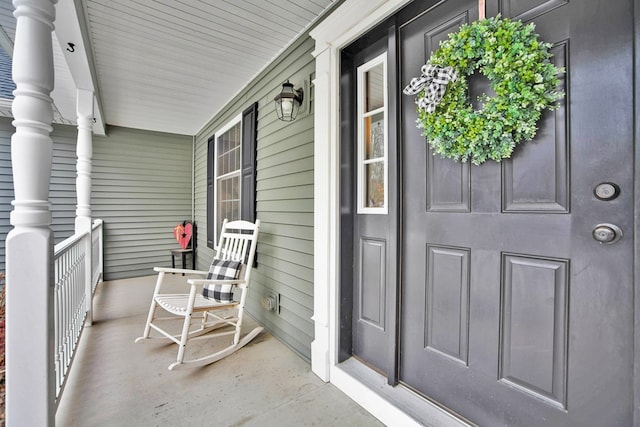 view of exterior entry with a porch