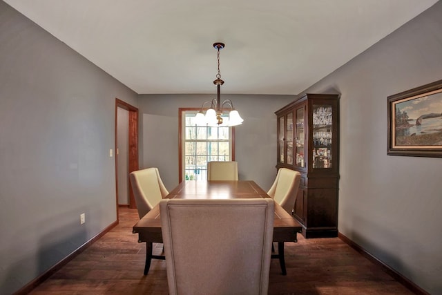 dining area featuring an inviting chandelier and dark hardwood / wood-style flooring