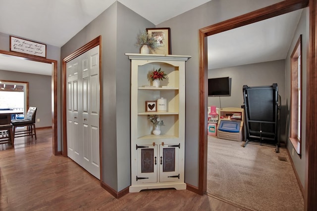 corridor with hardwood / wood-style floors