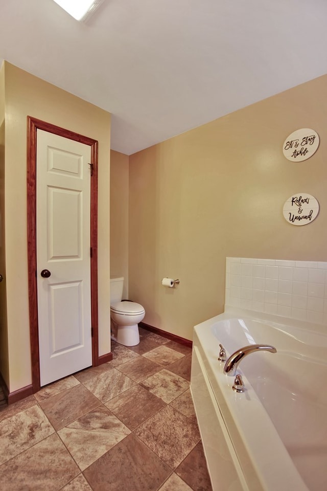 bathroom with a tub and toilet