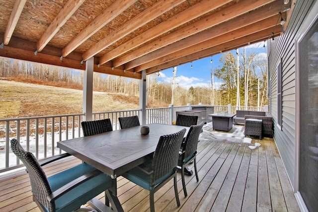 deck with an outdoor living space with a fire pit