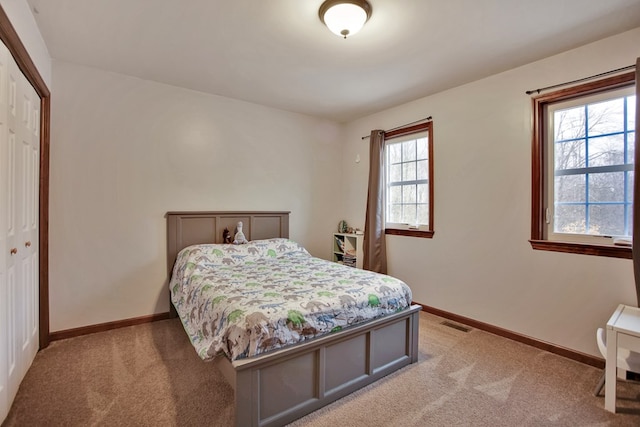 carpeted bedroom featuring a closet