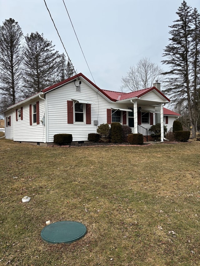 exterior space featuring metal roof, a porch, crawl space, and a front lawn