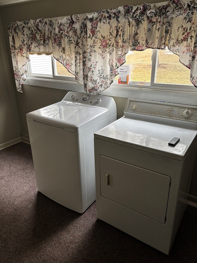 laundry area featuring washing machine and clothes dryer and baseboards