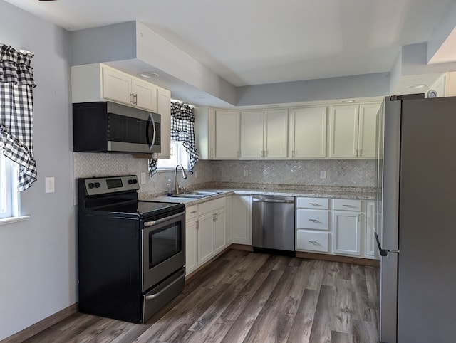 kitchen featuring tasteful backsplash, dark hardwood / wood-style flooring, sink, and stainless steel appliances