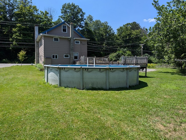 view of swimming pool with a lawn