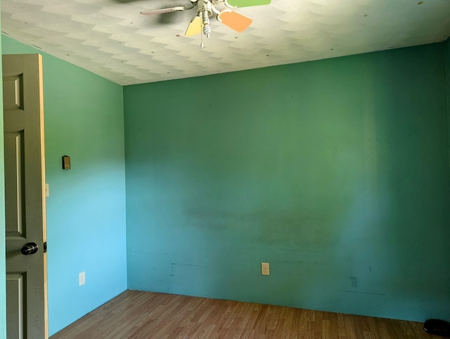 unfurnished room with a textured ceiling, light hardwood / wood-style floors, and ceiling fan