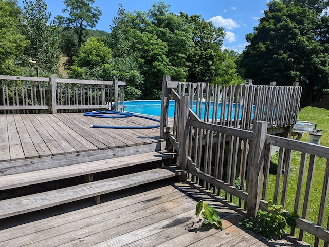 view of swimming pool featuring a wooden deck