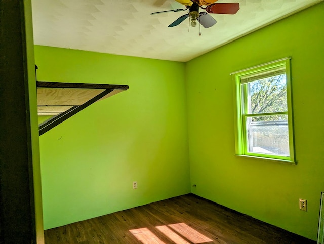 empty room with dark hardwood / wood-style flooring and ceiling fan