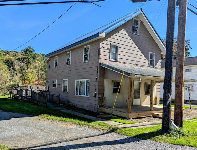 back of house featuring covered porch