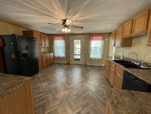 kitchen with parquet flooring, ceiling fan, sink, black appliances, and a baseboard radiator