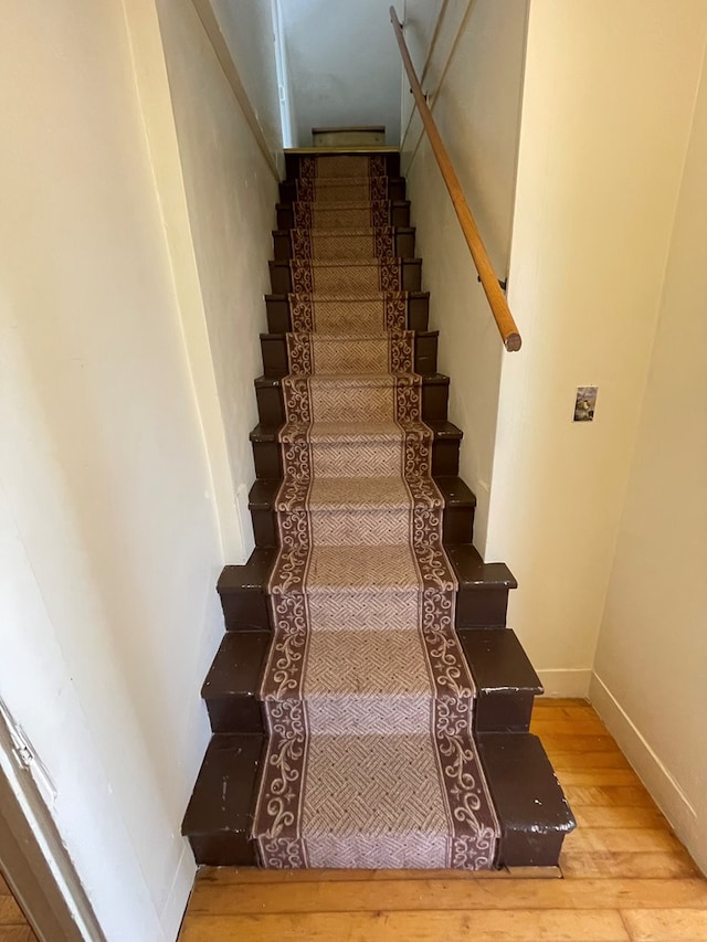 stairway featuring hardwood / wood-style floors