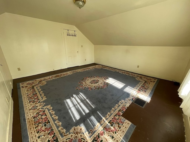 additional living space featuring vaulted ceiling