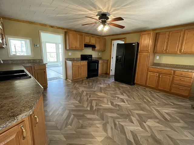 kitchen with dark parquet flooring, black appliances, sink, ceiling fan, and ornamental molding