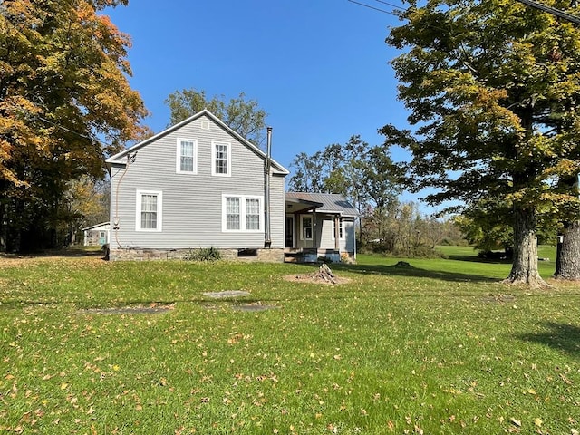 back of property featuring a yard