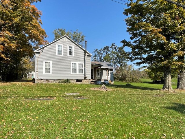 view of side of property with a yard