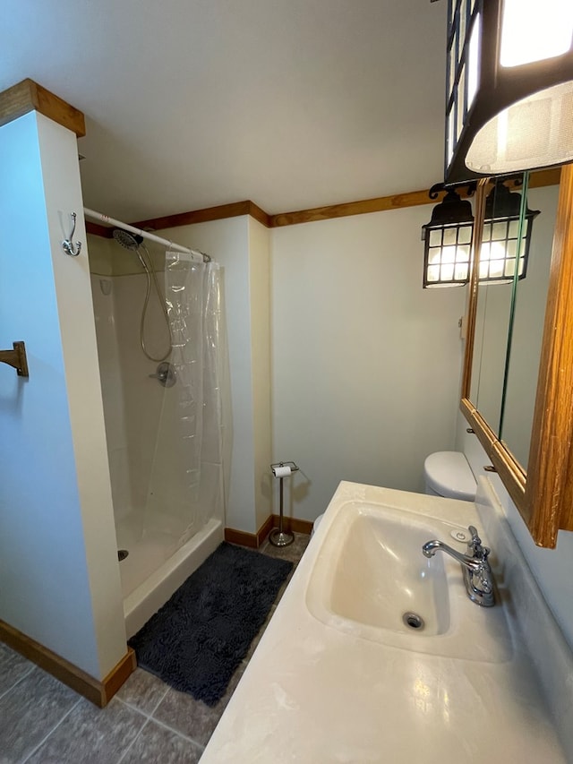 bathroom featuring curtained shower, ornamental molding, and sink