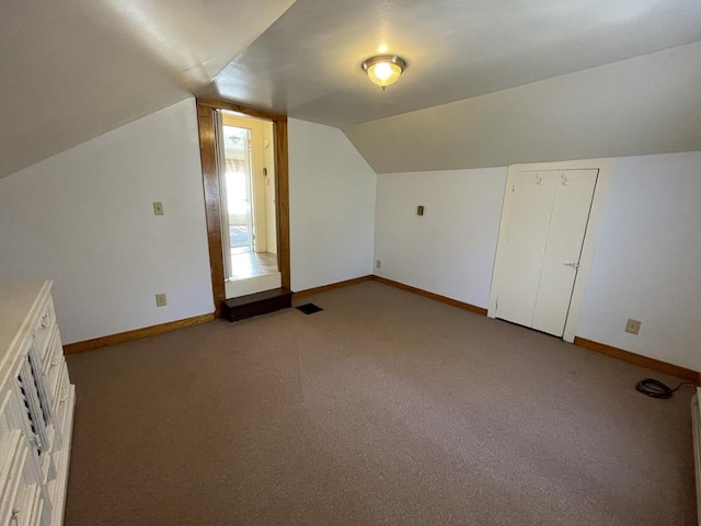 additional living space with lofted ceiling and light colored carpet