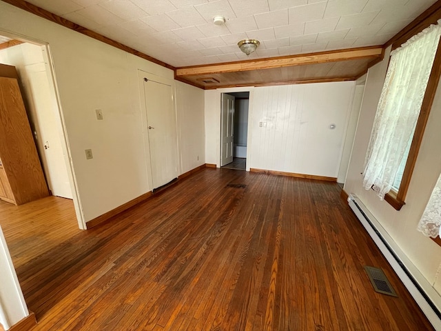 unfurnished bedroom featuring a baseboard heating unit and dark wood-type flooring